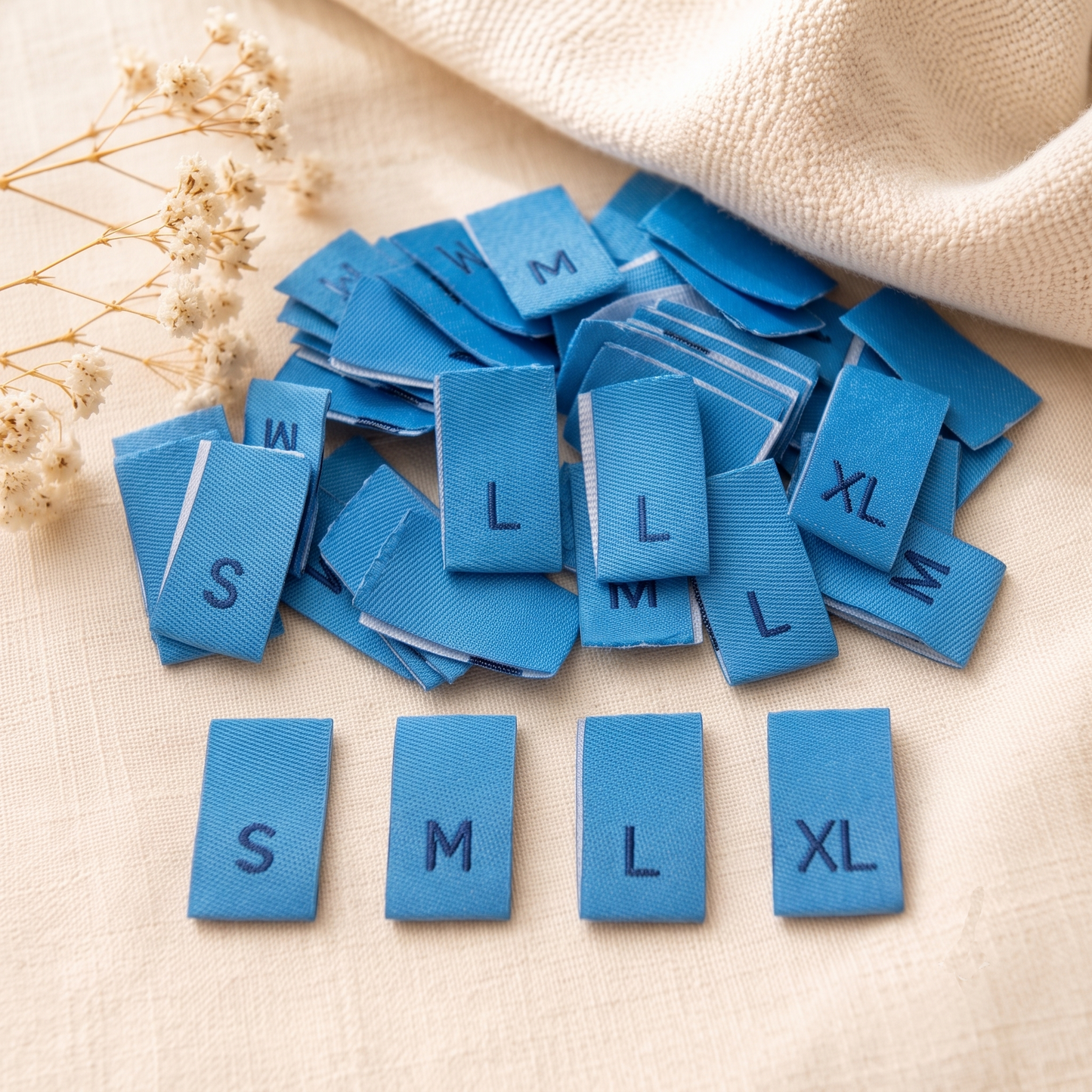 Blue damask woven size labels with S, M, L and XL letters for clothing and handmade garments